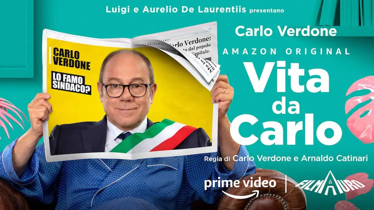 , con Carlo seduto su un divano che legge un giornale